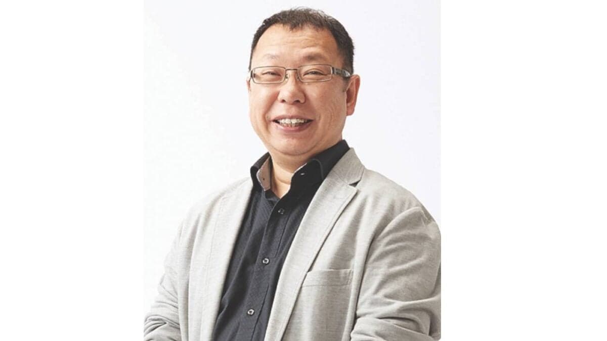 Takashi Tezuka smiling during a Nintendo presentation about game development