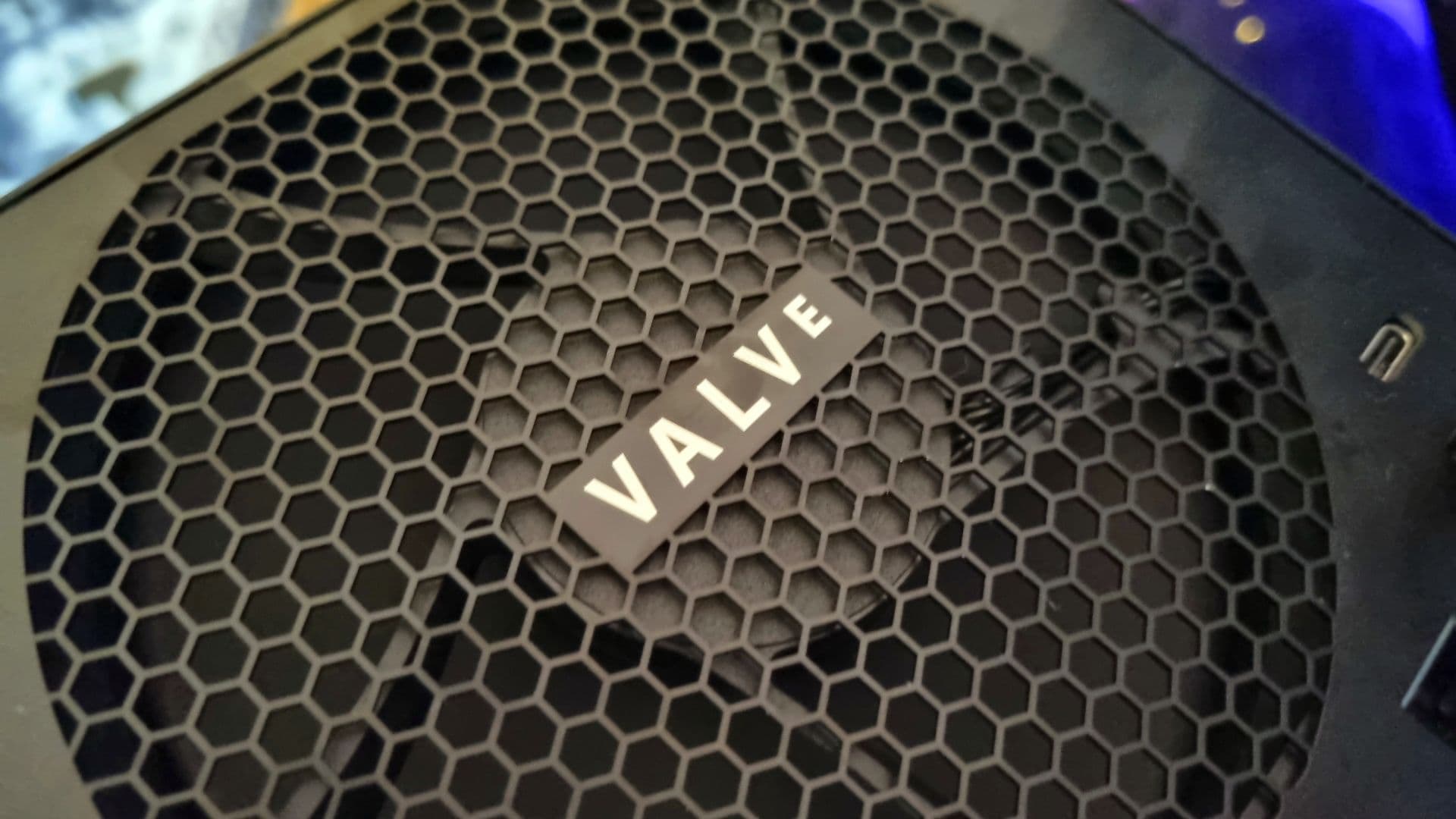 Valve Steam Machine hardware sitting on a desk with RGB lighting in background